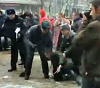 Police help LGBTI protester to stand after attack. (Click image for video from Vremya Voronezha via YouTube)