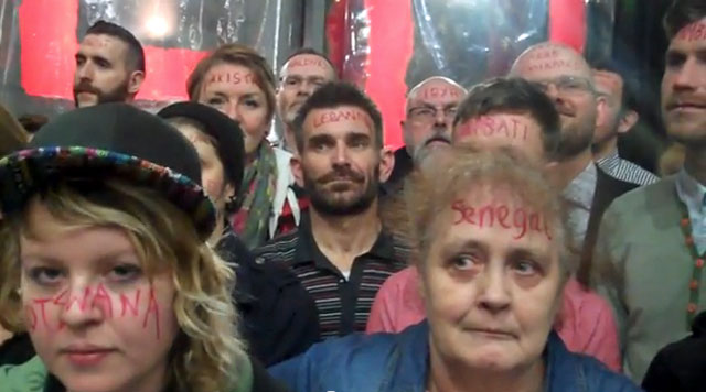 Protesters had their faces painted with the names of 76-plus countries with anti-LGBT laws. (Click image to see the video.)