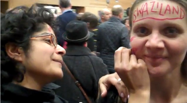 Protester in Brighton has her face labeled "Swaziland" in hopes that the country will repeal its anti-gay law. (Click image for video.)