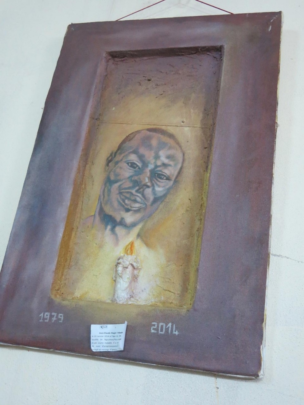 A painting in memory of Roger Mbede hangs in the office of a Cameroonian LGBT organization. (Robbie Corey-Boulet photo courtesy of Al Jazeera)