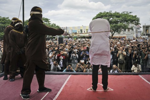 Public caning of a gay couple -- a sharia court's punishment for their homosexual activity -- was carried out May 23 outside a mosque in Banda Aceh, Aceh province, Indonesia. (Photo courtesy of The Washington Post)