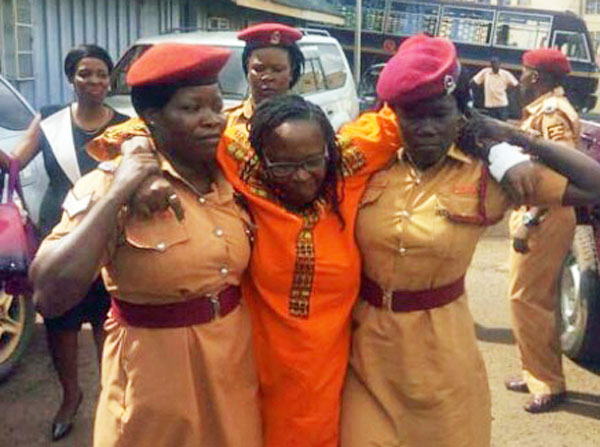 Back in 2017, prison officers had to assist Stella Nyanzi before her appearance in court on the first set of charges she faced for insulting President Yoweri Museveni. She was suffering from malaria. (Betty Ndagire photo courtesy of the Daily Monitor)
