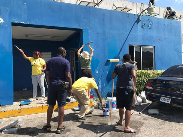 LGBT community members at Montego Bay Pride paint the Freeport Police Station. (Photo courtesy of Maurice Tomlinson)