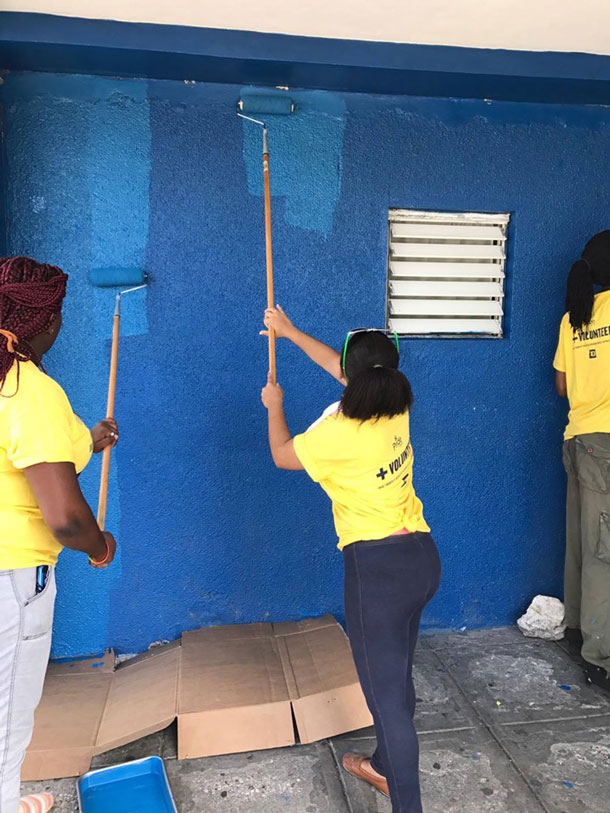 LGBT community members at Montego Bay Pride 2017 use paint rollers to spruce up the Freeport Police Station. (Photo courtesy of Maurice Tomlinson)