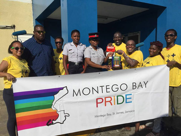 Freeport police and LGBT community members pose together at the police station, the site of Montego Bay Pride's 2017 social service project. (Photo courtesy of Maurice Tomlinson)