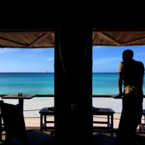 An LGBT rights activist looks out over a beach and the Caribbean Sea on the eastern Caribbean island of Barbados. (Amy Braunschweiger photo courtesy of Human Rights Watch)