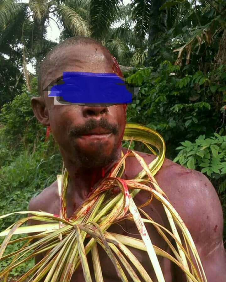 A victim mockingly dressed in palm leaves.