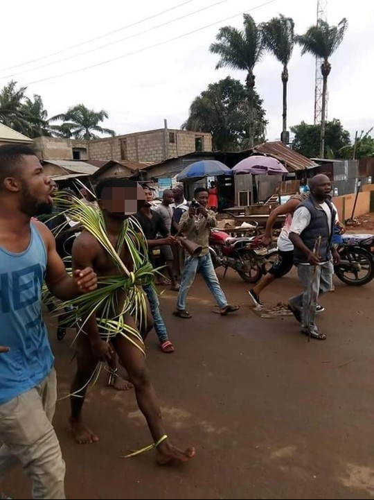 A scornful crowd marched the two victims through the streets.