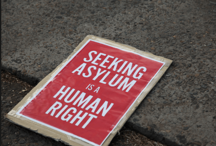 With this photo, the African Human Rights Coalition explains its support for asylum-seekers from Uganda and other anti-LGBT nations.