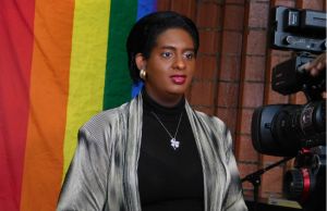 Alexa Hoffman and rainbow flag (Photo courtesy of GayTourism.travel)