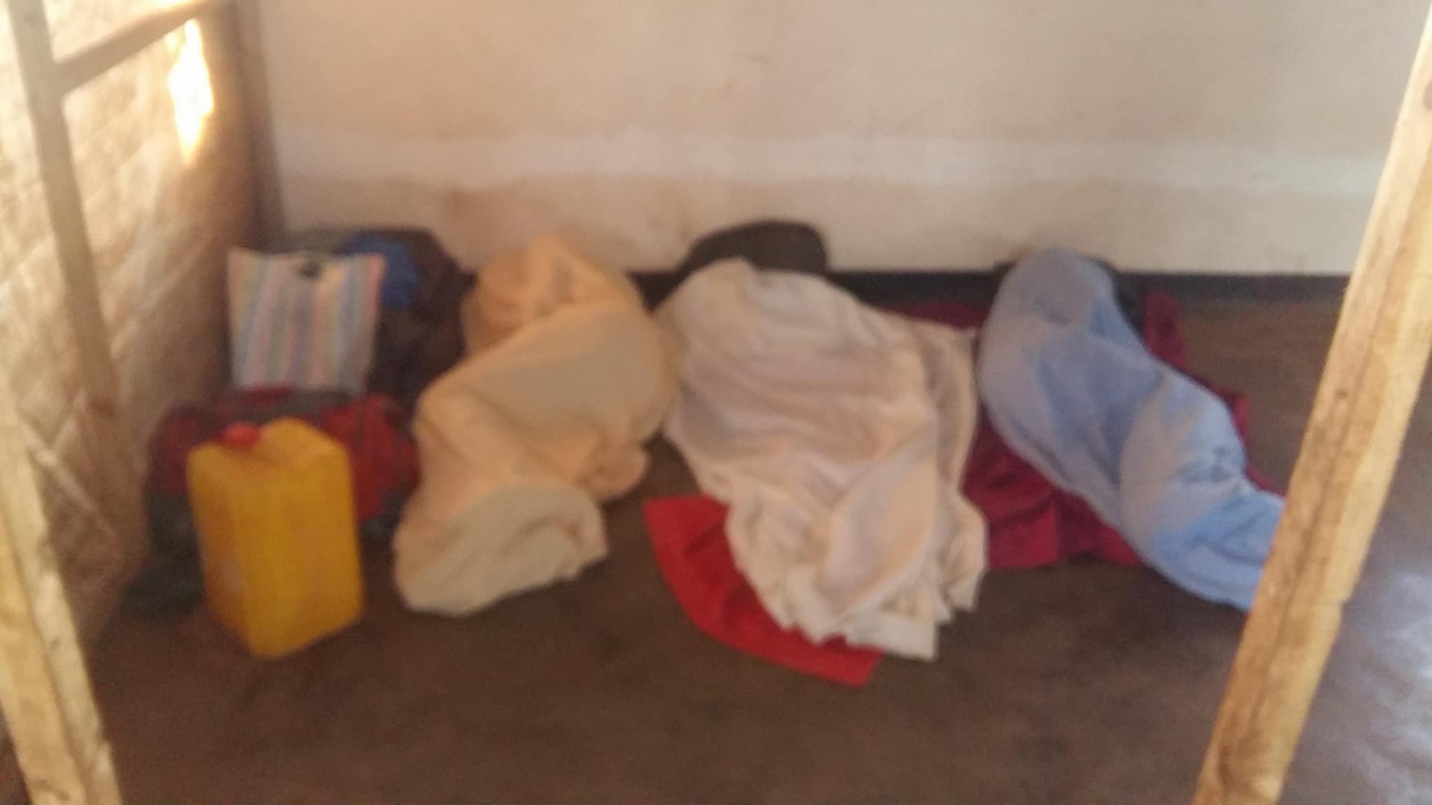 Three Ugandan LGBTI refugees sleep on the ground in Malawi. (Photo courtesy of Refugee Flag Kakuma)