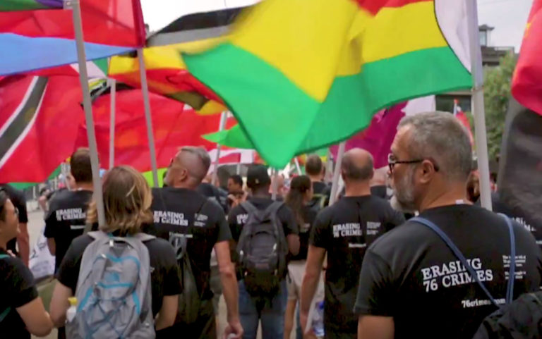 During Amsterdam Pride 2018, marchers in Erasing 76 Crimes t-shirts carried the flags of repressive nations to pressure them to repeal their anti-LGBT laws.