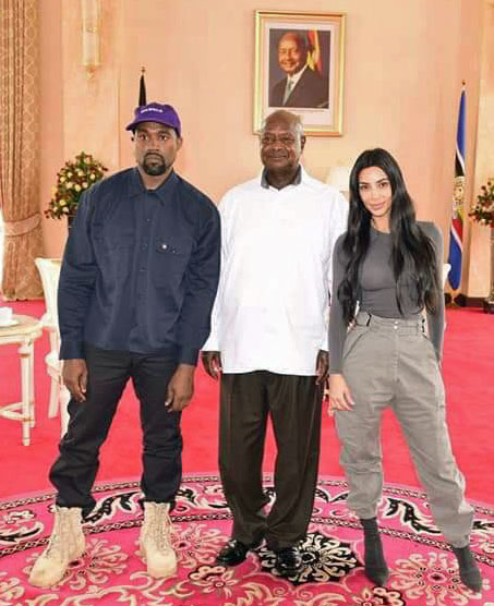 In front of a photo of Ugandan President Yoweri Museveni that Museveni has on display, he poses with American celebrities Kanye West and Kim Kardashian. (Photo courtesy of Twitter)