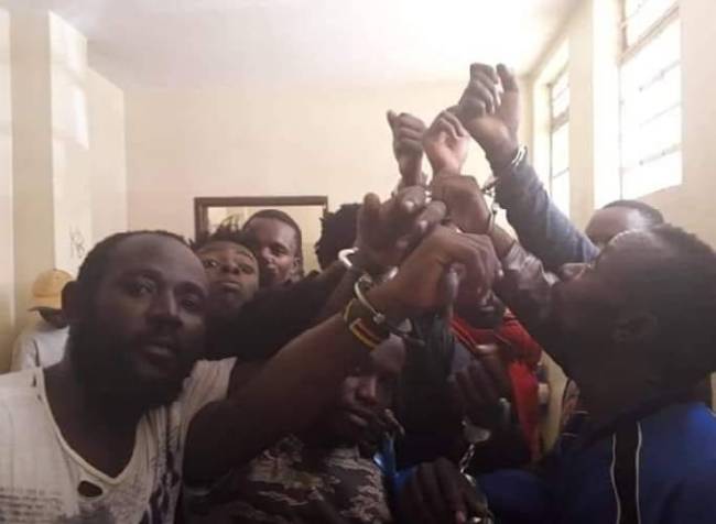 LGBTI refugees in Kenya protest in handcuffs. (Photo courtesy of Refugee Flag Kenya via Facebook)