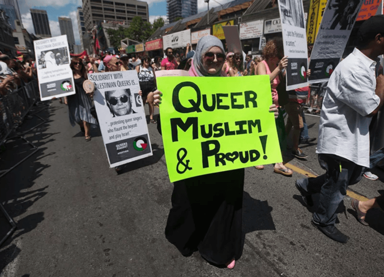 A woman marching in the Tornonto Pride Parade in 2012 carries a sign that reads, "Queer, Muslim and Proud." (Mark Blinch photo courtesy of Religion News/Reuters)