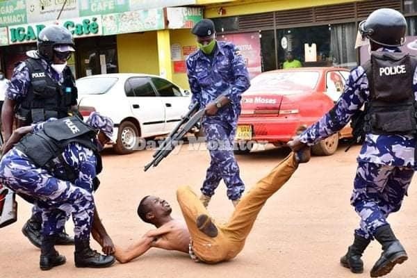 A Ugandan man begs for his life at the hands of Uganda Police. (Photo courtesy of the Daily Monitor)