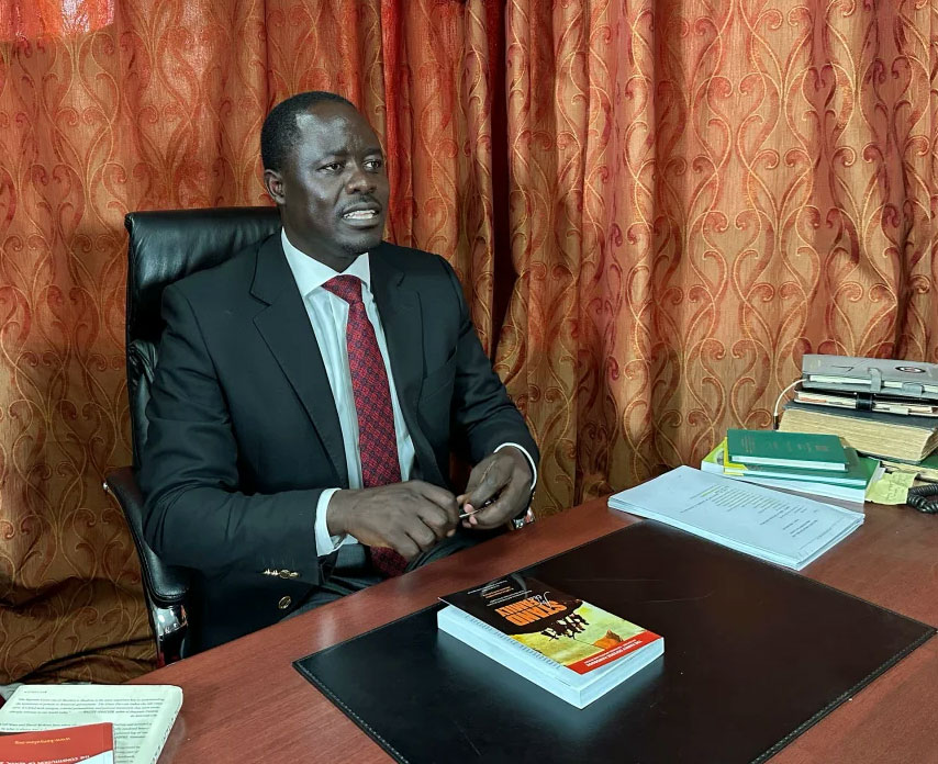 Kenyan opposition politician Peter Kaluma, the main sponsor of an anti-homosexuality bill in 2023, shows a copy of Sharon Slater's book, "Stand For The Family," in his office in Nairobi. (Sarah Dean photo courtesy of CNN)