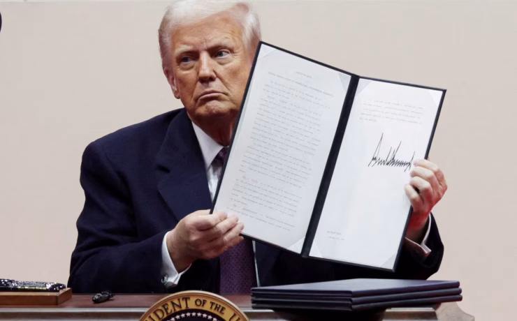 U.S. President Donald Trump displays a newly signed executive order on Jan. 20, 2025. (Photo courtesy of Reuters)