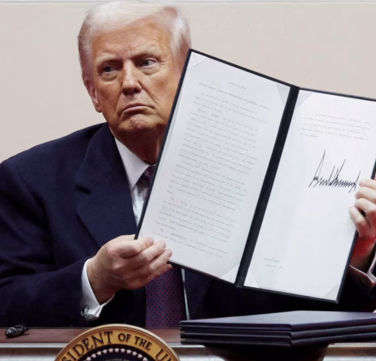 U.S. President Donald Trump displays a newly signed executive order on Jan. 20, 2025. (Photo courtesy of Reuters)