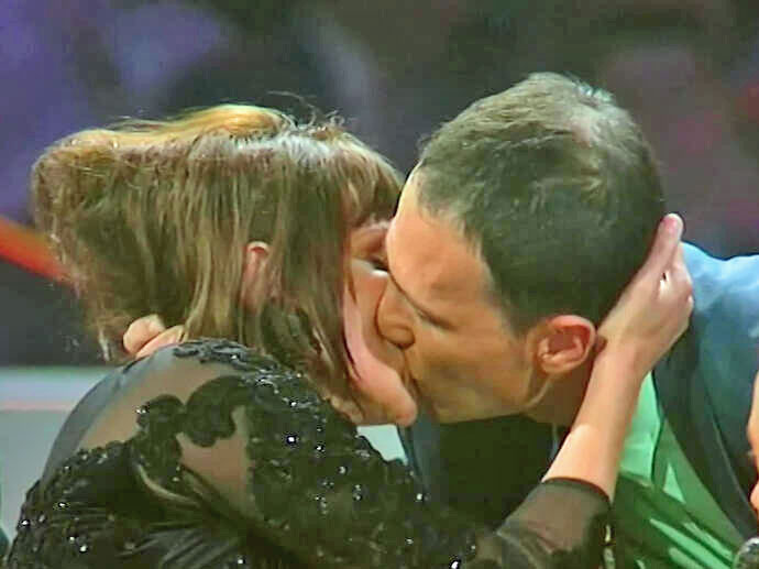 French actress Clémentine Célarié kisses an HIV-positive man on TV in 1994 to dispel misinformation about the virus.