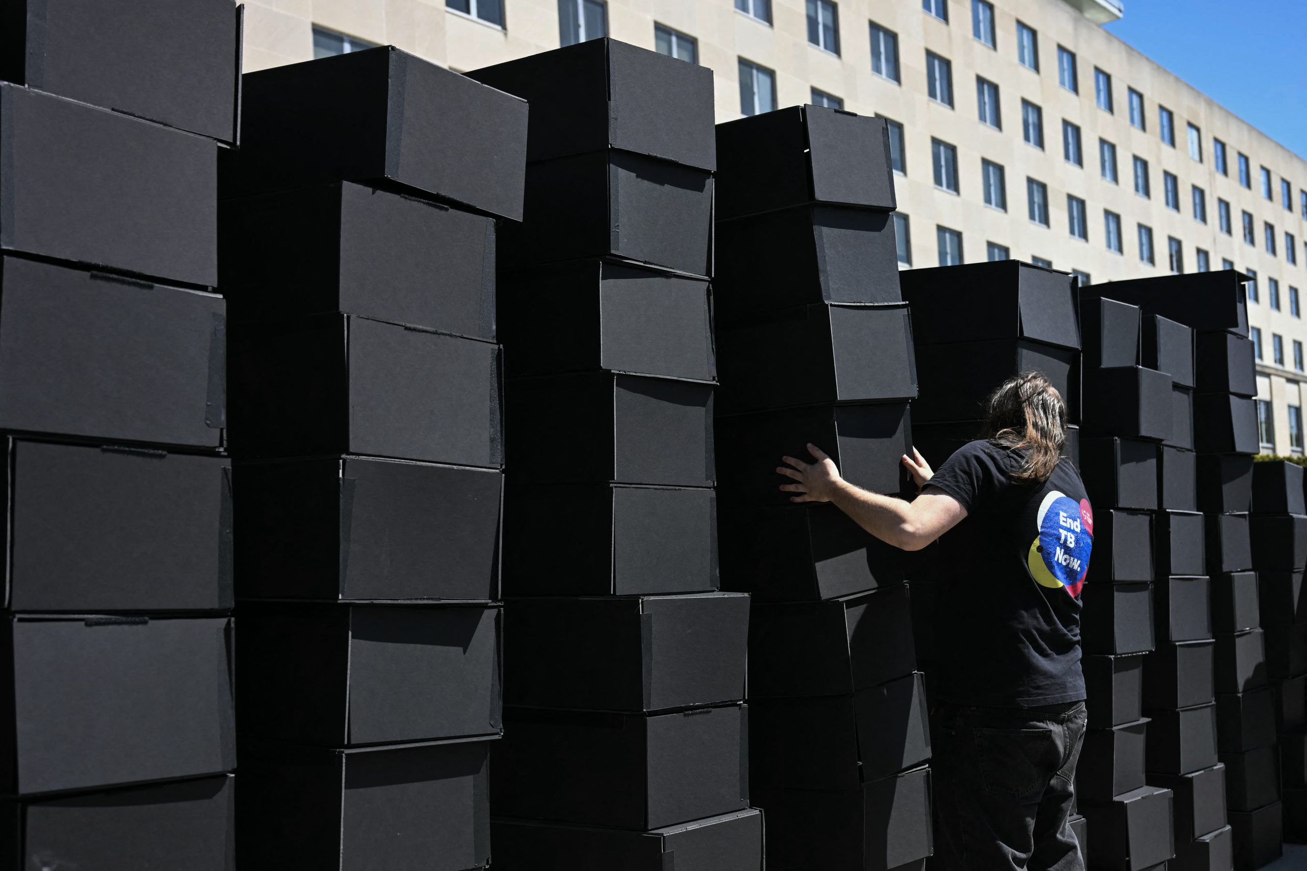 HIV advocates pile up hundred of mock coffins in front of the U.S. State Department. (Photo courtesy of Pink News / AFP / Getty)