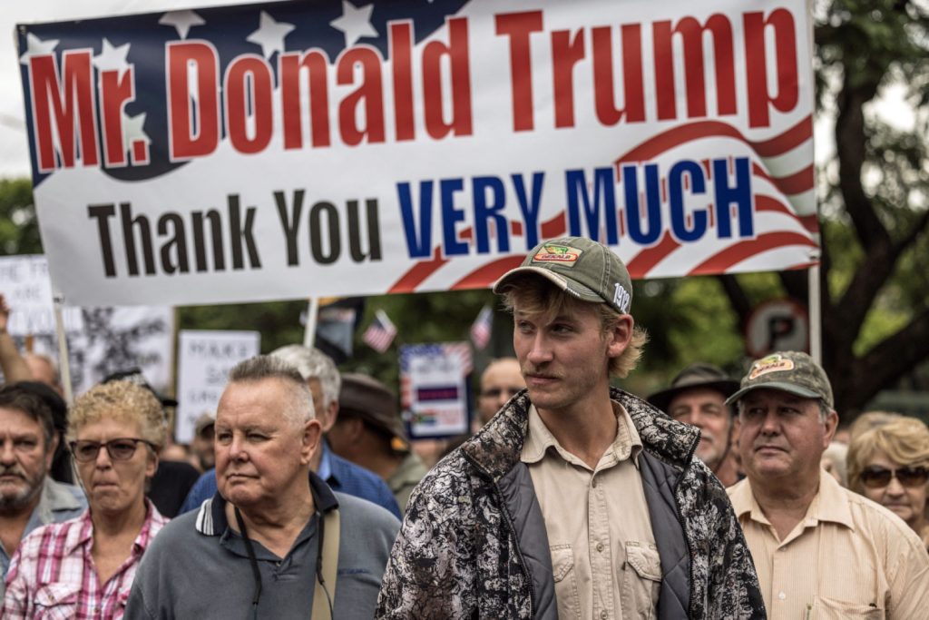 White South Africans show their gratitude for Donald Trump's decision to accept them as asylum-seekers in the United States. (Marco Longari photo courtesy of AFP / Getty / Rolling Stone)