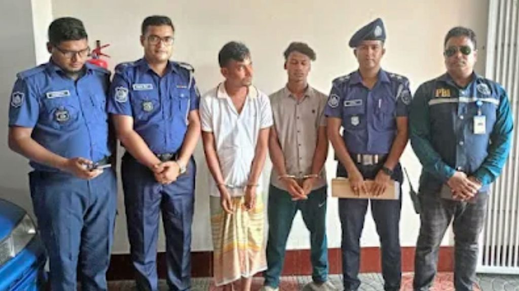 Bangladeshi police pose with two arrested suspects in the murder of Rafiqul Islam. They were only identified as Nayon and Al-Amin. (Photo courtesy of JMBF)