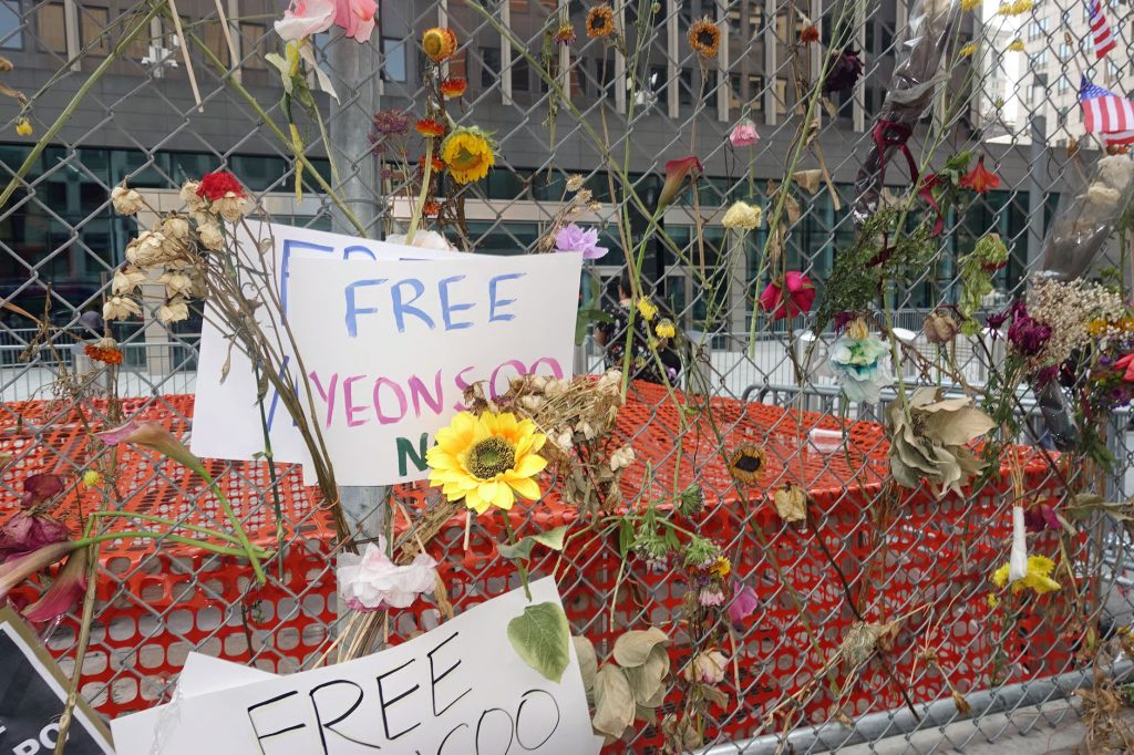Protesters opposed to U.S. Immigration and Customs Enforcement tactics left these posters and flowers outside ICE offices in New York. (Josh Russell photo courtesy of Courthouse News Service)