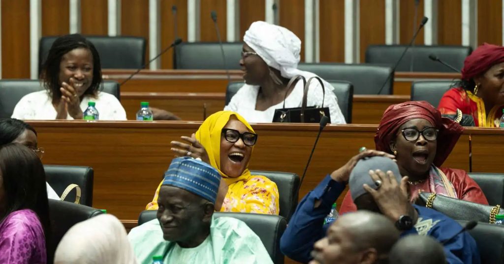 Anti-gay legislators at Senegal's National Assemby in Dakar celebrate the passage of the bill to double the penalties for same-sex intimacy. (Seyllou photo courtesy of AFP / Getty Images)