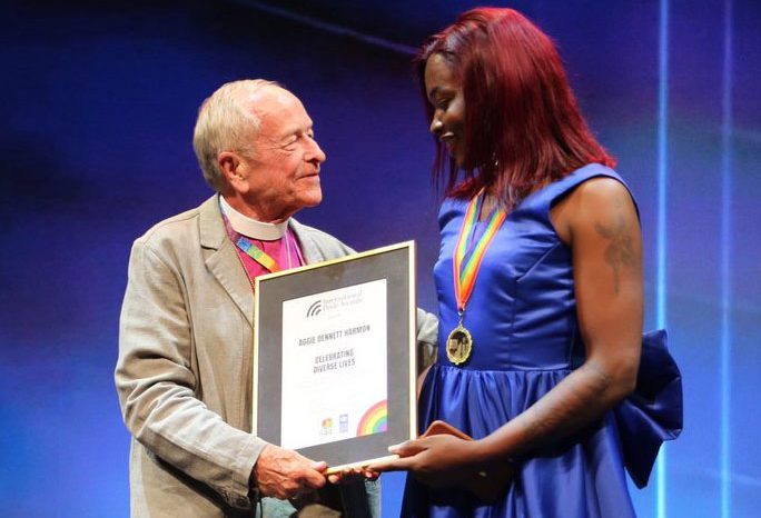 Episcopal Bishop Gene Robinson presents award to Ugandan pastor Aggie Dennett Harmon. (Photo courtesy of ILGA World)