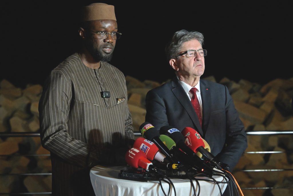 In 2024, the then Senegalese prime minister Ousmane Sonko (left) speaks alongside Jean-Luc Melenchon, founder of the La France Insoumise (LFI) party, during a press conference in Dakar. (Photo courtesy of Seyllou / AFP / Tetu)
